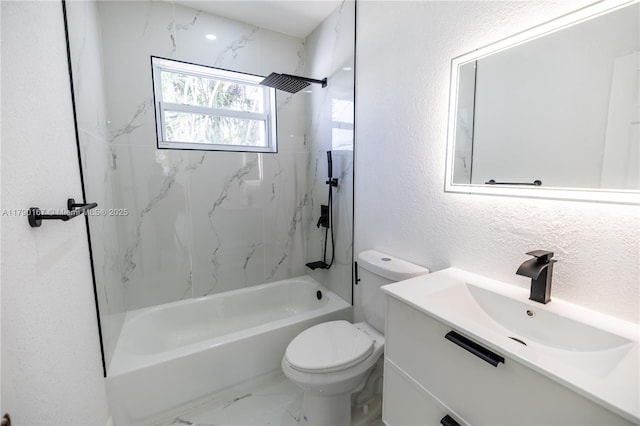 bathroom featuring vanity, marble finish floor, a textured wall, shower / washtub combination, and toilet