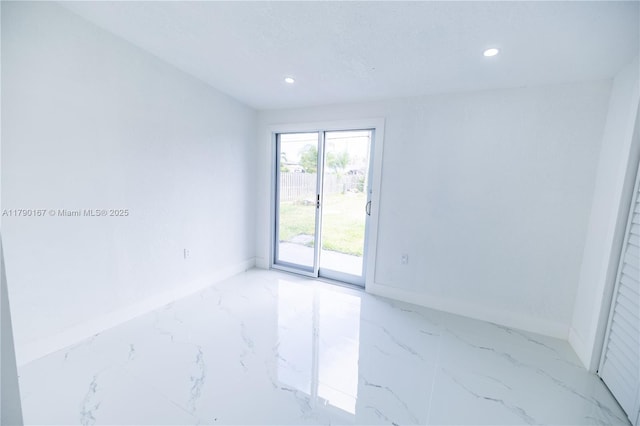 spare room featuring baseboards, recessed lighting, and marble finish floor