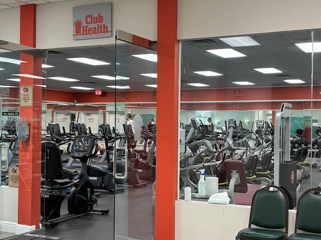 gym featuring a drop ceiling