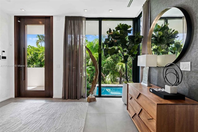 entryway featuring tile patterned flooring, a wall of windows, and plenty of natural light
