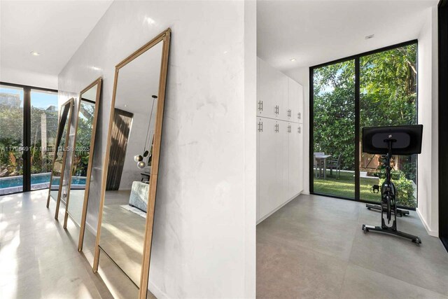 121 2nd Dilido Ter, Share A, Miami Beach, FL 33139 - interior space featuring french doors, a healthy amount of sunlight, concrete flooring, and expansive windows