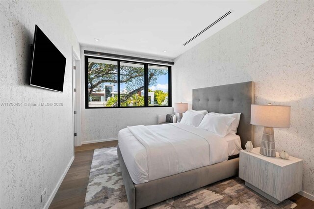 121 2nd Dilido Ter, Share A, Miami Beach, FL 33139 - bedroom featuring wood finished floors and a textured wall