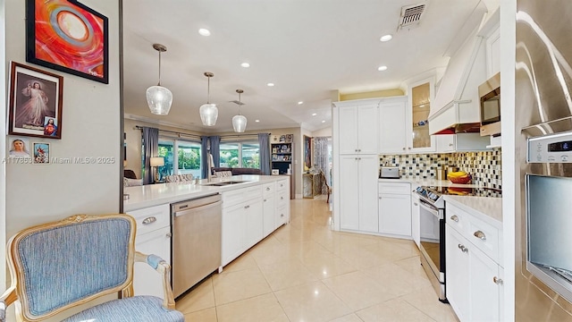 982 NW 133rd Ct, Miami, FL 33182 - kitchen with appliances with stainless steel finishes, light countertops, recessed lighting, ornamental molding, and glass insert cabinets