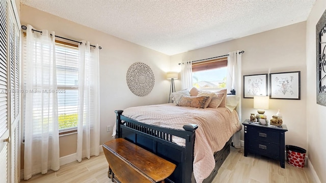 982 NW 133rd Ct, Miami, FL 33182 - bedroom with multiple windows, light wood-style floors, and a textured ceiling