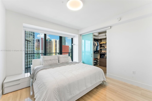 1451 Brickell Ave Unit 1803, Miami, FL 33131 - bedroom featuring baseboards, wood finished floors, and a closet