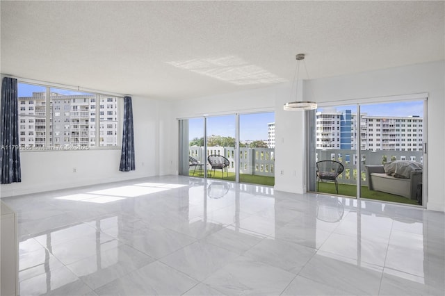 4001 Hillcrest Dr Unit 601, Hollywood, FL 33021 - empty room featuring a textured ceiling, marble finish flooring, and a city view
