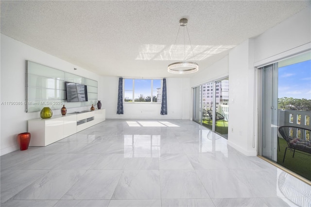 4001 Hillcrest Dr Unit 601, Hollywood, FL 33021 - unfurnished living room featuring marble finish floors, a textured ceiling, and healthy amount of natural light
