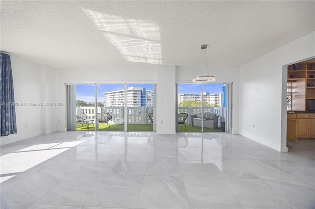 4001 Hillcrest Dr Unit 601, Hollywood, FL 33021 - spare room with light marble finish flooring, a textured ceiling, a chandelier, and a city view