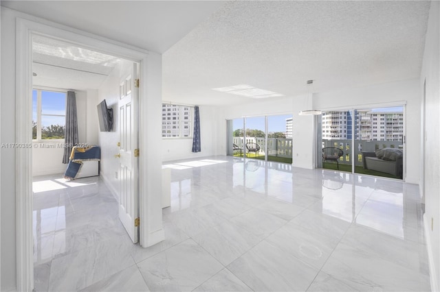 4001 Hillcrest Dr Unit 601, Hollywood, FL 33021 - unfurnished room with marble look tiles and a textured ceiling