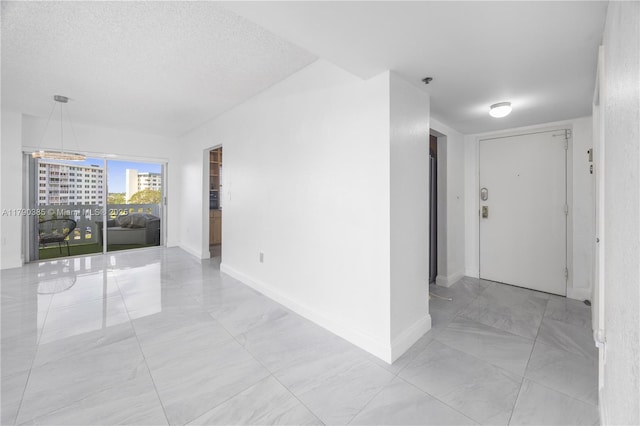 4001 Hillcrest Dr Unit 601, Hollywood, FL 33021 - spare room with light marble finish flooring, a pendent fire sprinkler, and a chandelier