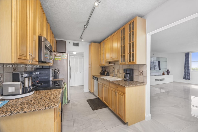 4001 Hillcrest Dr Unit 601, Hollywood, FL 33021 - kitchen with stainless steel appliances, tasteful backsplash, light marble finish flooring, rail lighting, and stone countertops