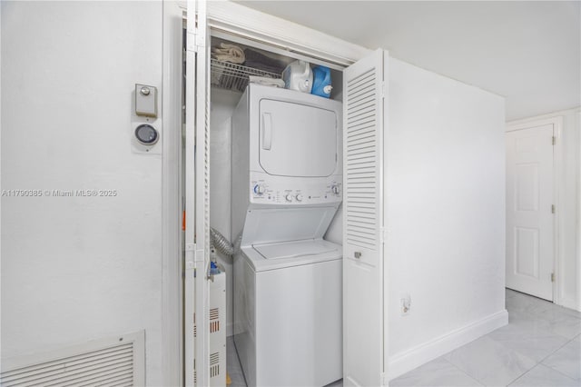 4001 Hillcrest Dr Unit 601, Hollywood, FL 33021 - laundry room featuring stacked washer / dryer and marble look tile flooring