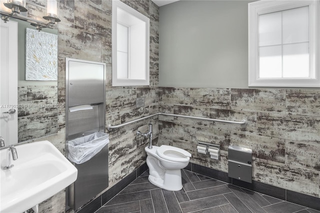 4001 Hillcrest Dr Unit 601, Hollywood, FL 33021 - half bath with tile walls, a bidet, and a wainscoted wall