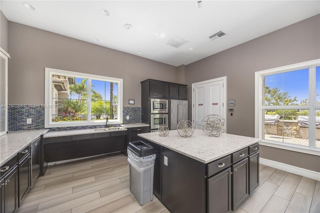 4001 Hillcrest Dr Unit 601, Hollywood, FL 33021 - kitchen featuring appliances with stainless steel finishes, backsplash, a center island, wood tiled floors, and recessed lighting