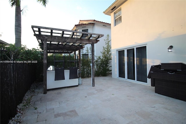view of patio / terrace featuring fence and a pergola