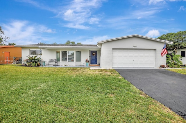 9460 NW 3rd St, Pembroke Pines, FL 33024 - ranch-style house with asphalt driveway, a garage, stucco siding, and a front yard