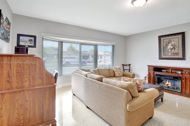 9460 NW 3rd St, Pembroke Pines, FL 33024 - living area with speckled floor, baseboards, and a glass covered fireplace