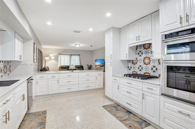 9460 NW 3rd St, Pembroke Pines, FL 33024 - kitchen with stainless steel appliances, light countertops, tasteful backsplash, a peninsula, and recessed lighting