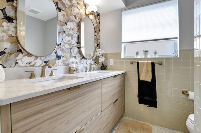9460 NW 3rd St, Pembroke Pines, FL 33024 - bathroom featuring tile walls, double vanity, toilet, and wainscoting