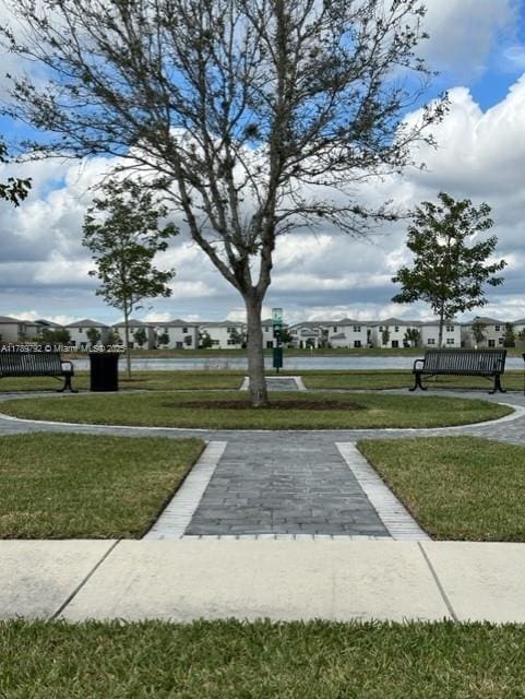 view of home's community featuring a lawn