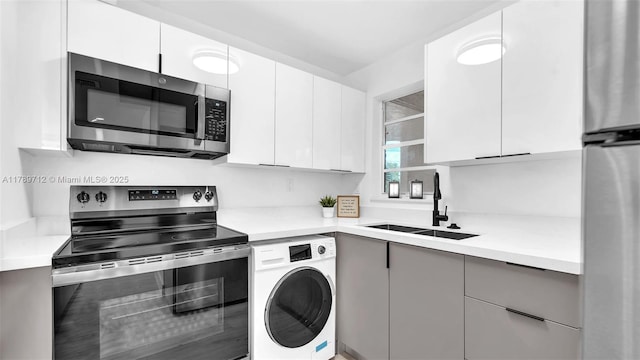 840 NW 87th Ave Unit 204, Miami, FL 33172 - kitchen featuring appliances with stainless steel finishes, washer / dryer, modern cabinets, and a sink