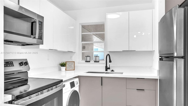 840 NW 87th Ave Unit 204, Miami, FL 33172 - kitchen with stainless steel appliances, washer / dryer, modern cabinets, and a sink