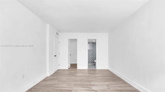 840 NW 87th Ave Unit 204, Miami, FL 33172 - unfurnished bedroom with a closet, visible vents, light wood-style flooring, baseboards, and ensuite bathroom