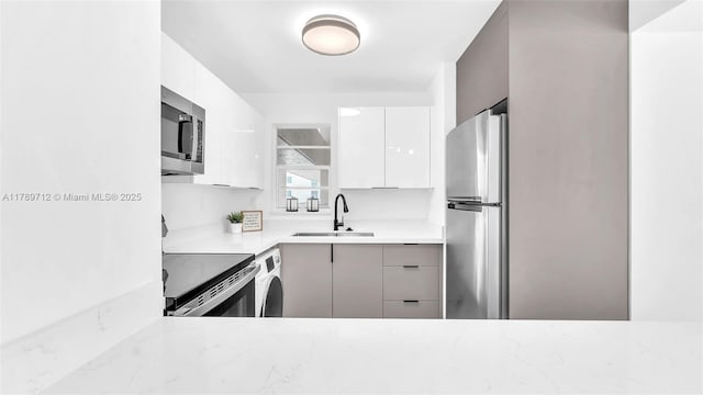 840 NW 87th Ave Unit 204, Miami, FL 33172 - kitchen with modern cabinets, a sink, light stone counters, and stainless steel appliances
