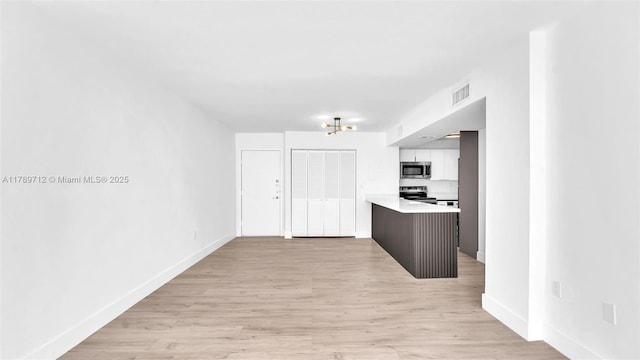 840 NW 87th Ave Unit 204, Miami, FL 33172 - kitchen featuring visible vents, baseboards, appliances with stainless steel finishes, and light countertops