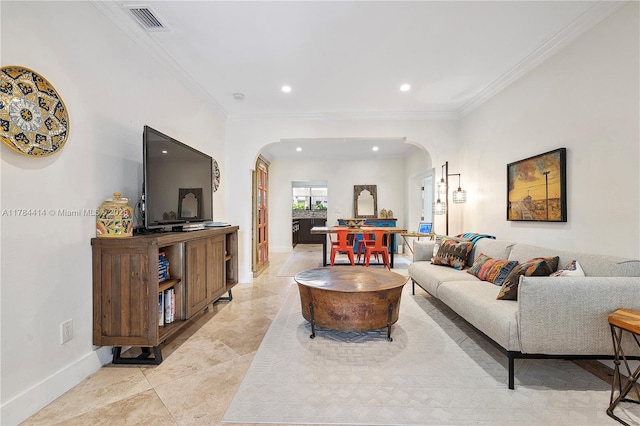 living area with arched walkways, visible vents, crown molding, and baseboards