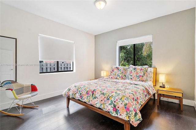 bedroom featuring baseboards and wood finished floors