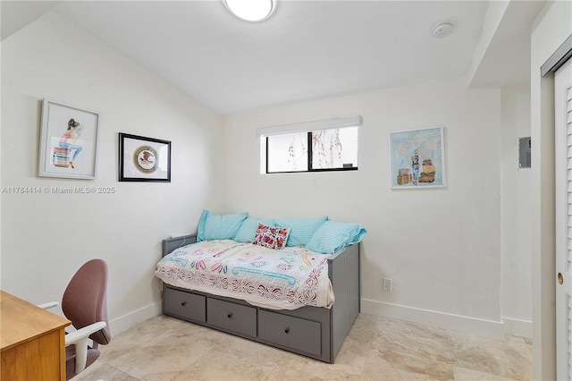 bedroom featuring baseboards and vaulted ceiling