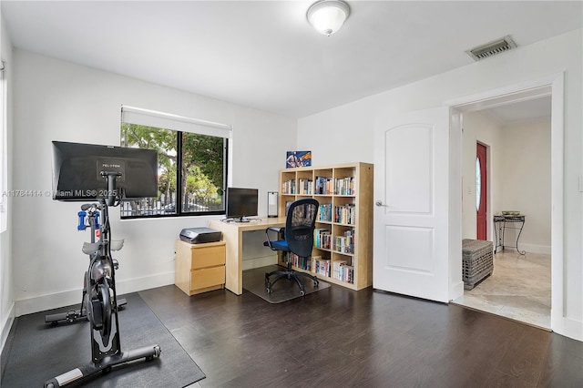 office featuring wood finished floors, visible vents, and baseboards