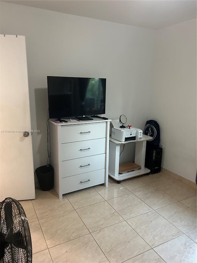 bedroom with light tile patterned floors