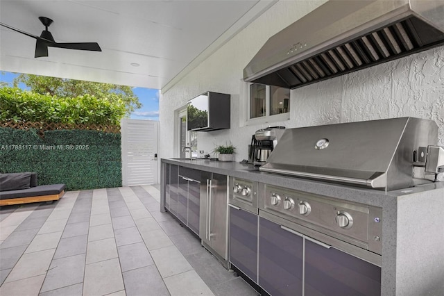 view of patio featuring fence, a ceiling fan, a sink, and exterior kitchen