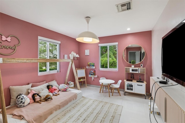 bedroom with baseboards, visible vents, and light tile patterned flooring