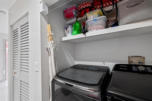 clothes washing area with washer and clothes dryer and laundry area