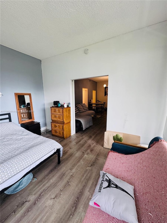 bedroom with wood finished floors and a textured ceiling