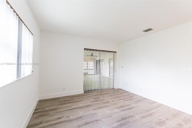 empty room with wood finished floors and baseboards