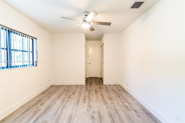 empty room with light wood-style floors, ceiling fan, and baseboards