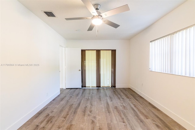 unfurnished bedroom with baseboards, light wood-style flooring, and ceiling fan