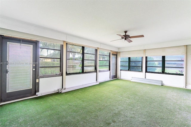 unfurnished sunroom with a ceiling fan and healthy amount of natural light
