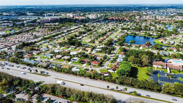 aerial view of property and surrounding area featuring a large body of water