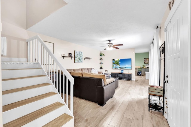 9153 SW 23rd St Unit D, Davie, FL 33324 - living room featuring light wood finished floors, a ceiling fan, and stairs
