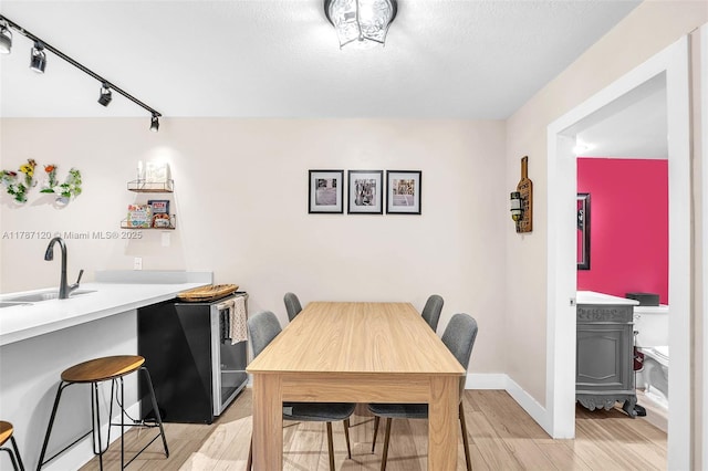 9153 SW 23rd St Unit D, Davie, FL 33324 - dining room featuring light wood-style floors, rail lighting, and baseboards