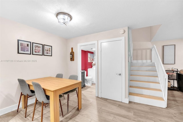 9153 SW 23rd St Unit D, Davie, FL 33324 - dining space with a textured ceiling, light wood-style floors, stairway, and washer / clothes dryer