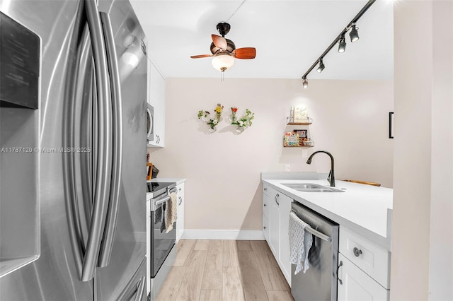 9153 SW 23rd St Unit D, Davie, FL 33324 - kitchen with stainless steel appliances, light countertops, a ceiling fan, a sink, and white cabinetry