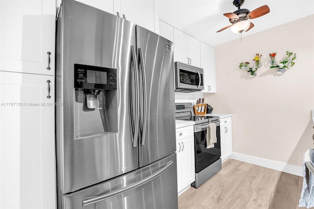 9153 SW 23rd St Unit D, Davie, FL 33324 - kitchen with stainless steel appliances, light wood finished floors, light countertops, white cabinets, and baseboards