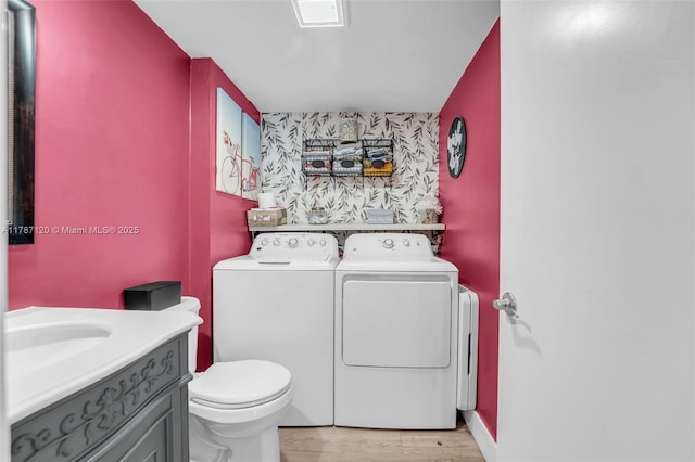 9153 SW 23rd St Unit D, Davie, FL 33324 - bathroom with toilet, an accent wall, wood finished floors, vanity, and washer and dryer