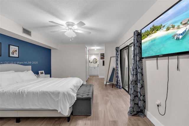 9153 SW 23rd St Unit D, Davie, FL 33324 - bedroom with connected bathroom, baseboards, wood finished floors, and visible vents